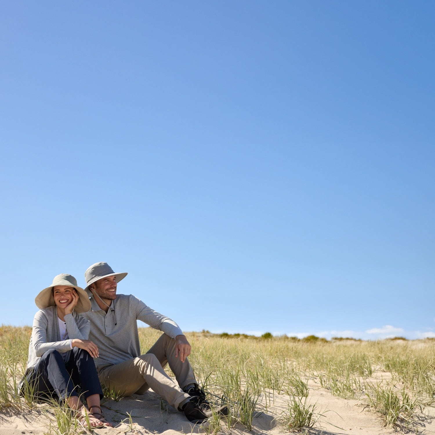 Woman and man wearing Solbari hats and tops.