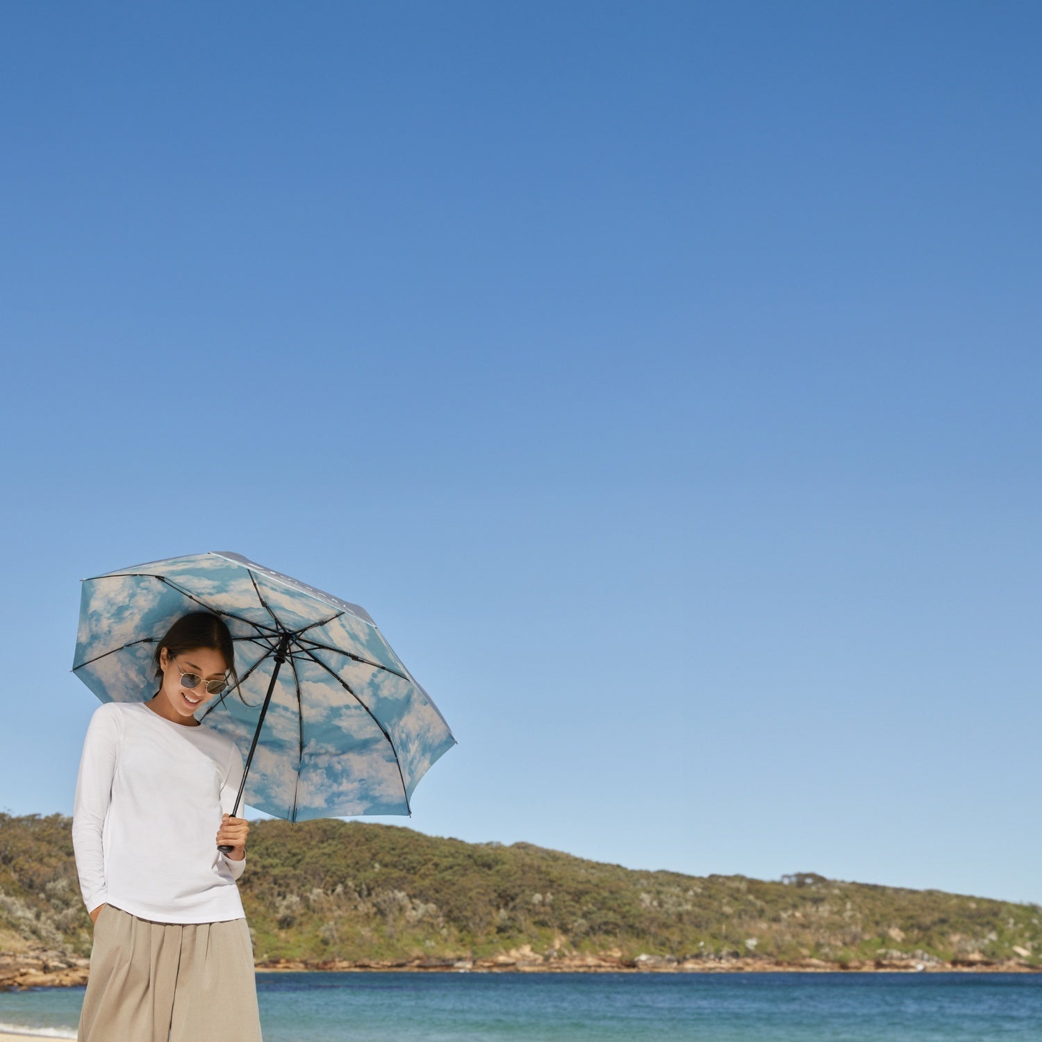Woman with umbrella on beach